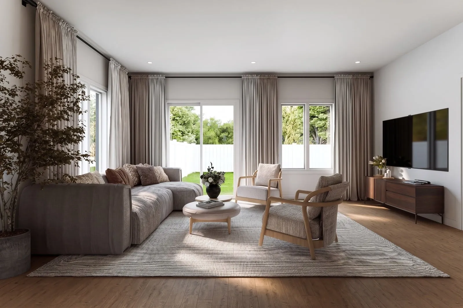 Sunlit Greenleaf living room with a sofa, lounge chairs and garden views